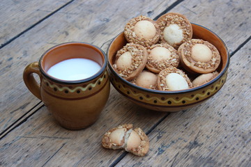 Clay cup of milk and a plate with cookies