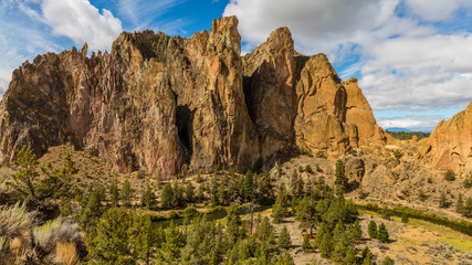 Naklejka na ściany i meble The river is flowing among the rocks. Colorful Canyon. Amazing landscape of yellow sharp cliffs. Smith Rock state park, Oregon