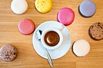 A beautiful  colorful macaroons and a Cup of hot chocolate on wooden background