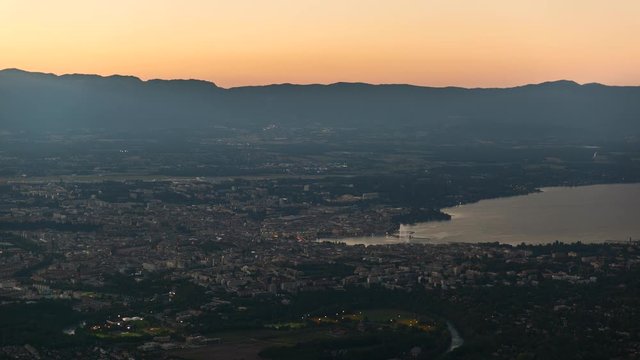 Aerial view of the city of Geneva and surroundings, day to night timelapse.