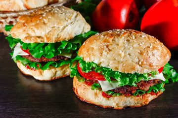 Close-up of home made tasty burgers on wooden table