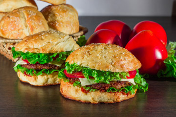 Close-up of home made tasty burgers on wooden table