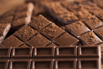 Dark and milk chocolate bar on a wooden table