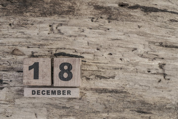 cube calendar for december on wooden background with copy space