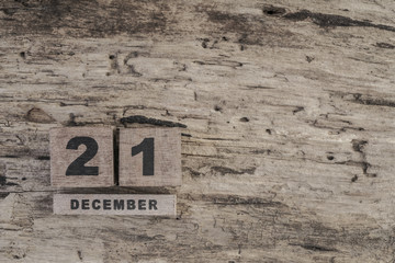cube calendar for december on wooden background with copy space