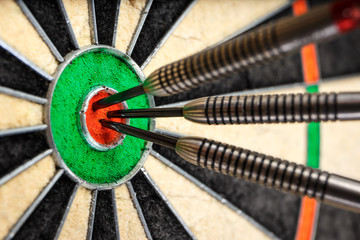 three darts in bull's eye, close up