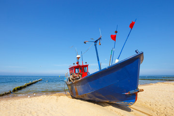 Fishing boat on the beach at summer time