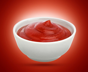 Ketchup in white bowl isolated on red background. Portion of tomato sauce. With clipping path.