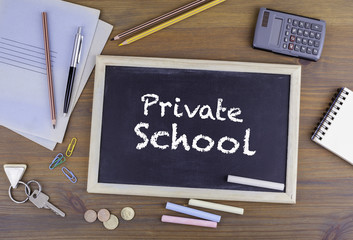 Private School. Chalkboard on wooden office desk