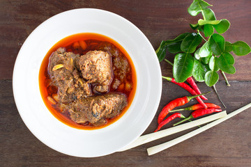 Beef massaman curry on wood background.
