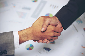 Business people handshake,signing agreement, graph, business charts,success  for business deal