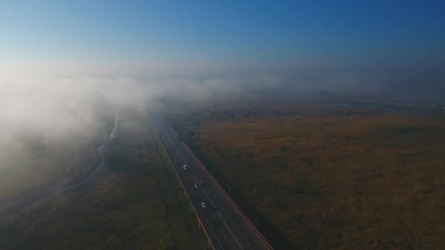 Autumn morning fog over highway. Aerial view.