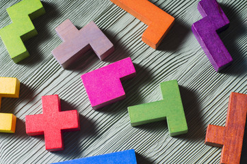 Wooden geometric shapes on a wooden background, close-up.