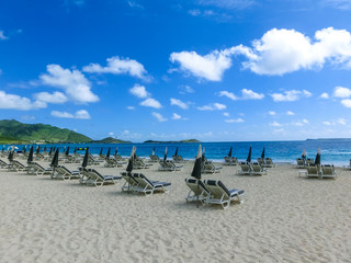 The chairs and umbrellas on tropical beach