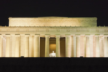 Illuminated eastern exterior of the Lincoln Memorial including the fluted Doric columns, attic...