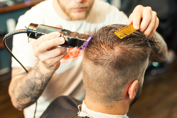 Young man having hair cutted