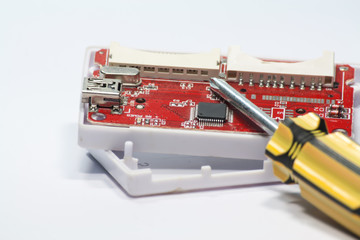 Fixing print circuit board with screwdriver.