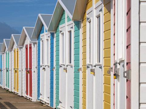 Row of locked English seaside chalets out of the vacation period
