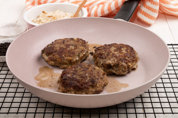 fried meat balls with sunflower oil in a pan