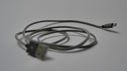 Fototapeta na wymiar graues, mini USB-Kabel auf weißem Hintergrund