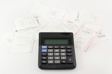 A calculator with receipt, household bills