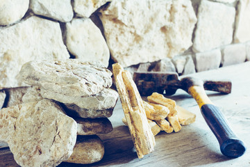 Stack Flagstone And Construction Hammer Against The Wall Of Stone Closeup. Concept Building, Repair