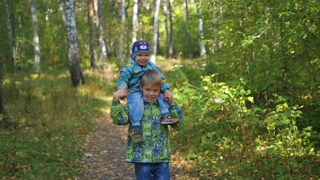 children run along the path in Park in autumn