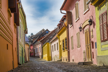 Beautiful traditional street inside citadel of Sighisoara (house of Dracula) in Transylvania region, Romania