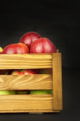 Fresh red autumn apples in farmhouse style wooden crate. Sales of farm products. Advertising for the sale of fruit.
