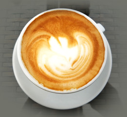 Delicious cappuccino coffee cup with cream froth