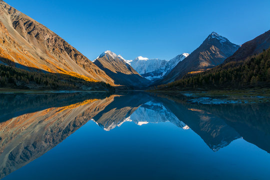 The Mountain Belukha in the reflection Akkem lake at sunset. Altai Mountains, Russia.