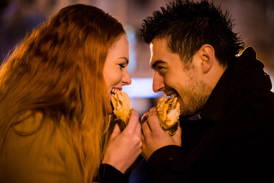 Couple duel - eating together in street