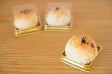 traditional chinese snack of preserved egg cakes on a wood table
