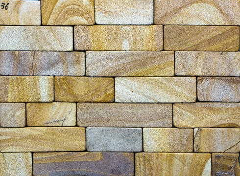 texture of yellow sandstone bricks close-up,