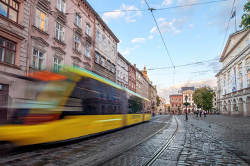 yellow tram rides on the morning  old european city.vintage 