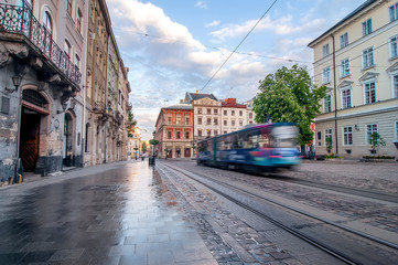 Fototapeta na wymiar yellow tram rides on the morning old european city.vintage 