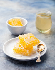 Honey, honeycombs on a grey stone background