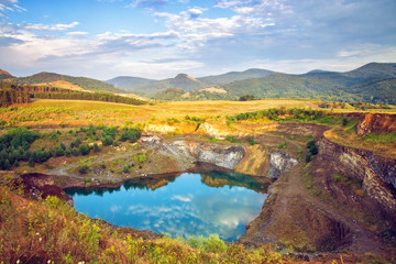 Fototapeta premium Beautiful landscape with small lake and mountain range in the background
