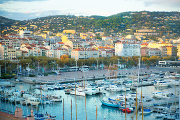 Fototapeta na wymiar CANNES, FRANCE - 19 SEPTEMBER, 2016: Vieux Port (old port) in the city of Cannes, with lots of sailing boats and power yachts anchored during the Sailing regatta