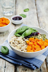 rice bowl with spinach, pumpkin, pumpkin seeds and cranberry sau