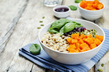 rice bowl with spinach, pumpkin, pumpkin seeds and cranberry sau
