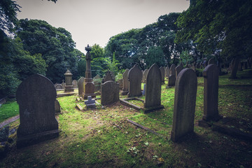 Graveyard in a wooded area with trees 