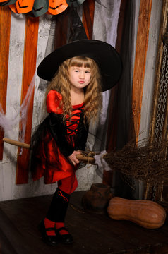 little halloween witch girl flying on broom