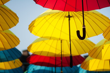  yellow and blue umbrellas under the beautiful cloudy sky. 