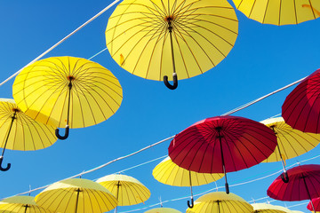 Obraz premium colorful umbrellas under the beautiful cloudy sky. 