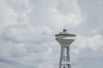 water Tower under white cloudy skies