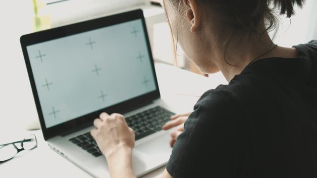 Woman working on laptop at home interier near the window. Hands and fingers on the keyboard close-up