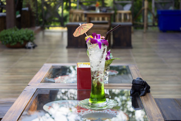 Kiwi italian soda cocktail drink on a table and beautiful backgr