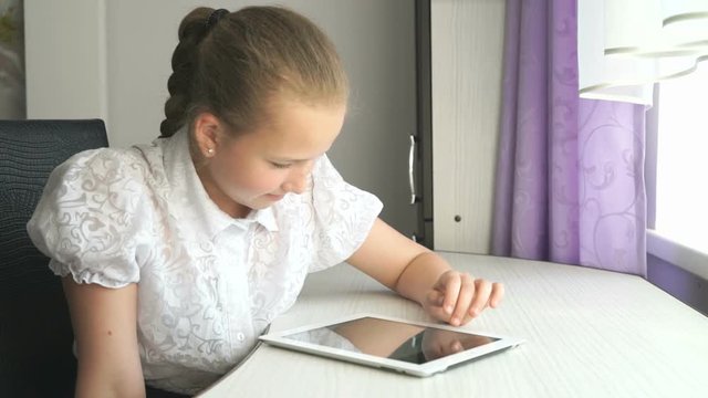 Primary schoolgirl using a digital tablet computer