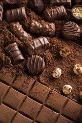 Dark homemade chocolate bars and cocoa pod on wooden